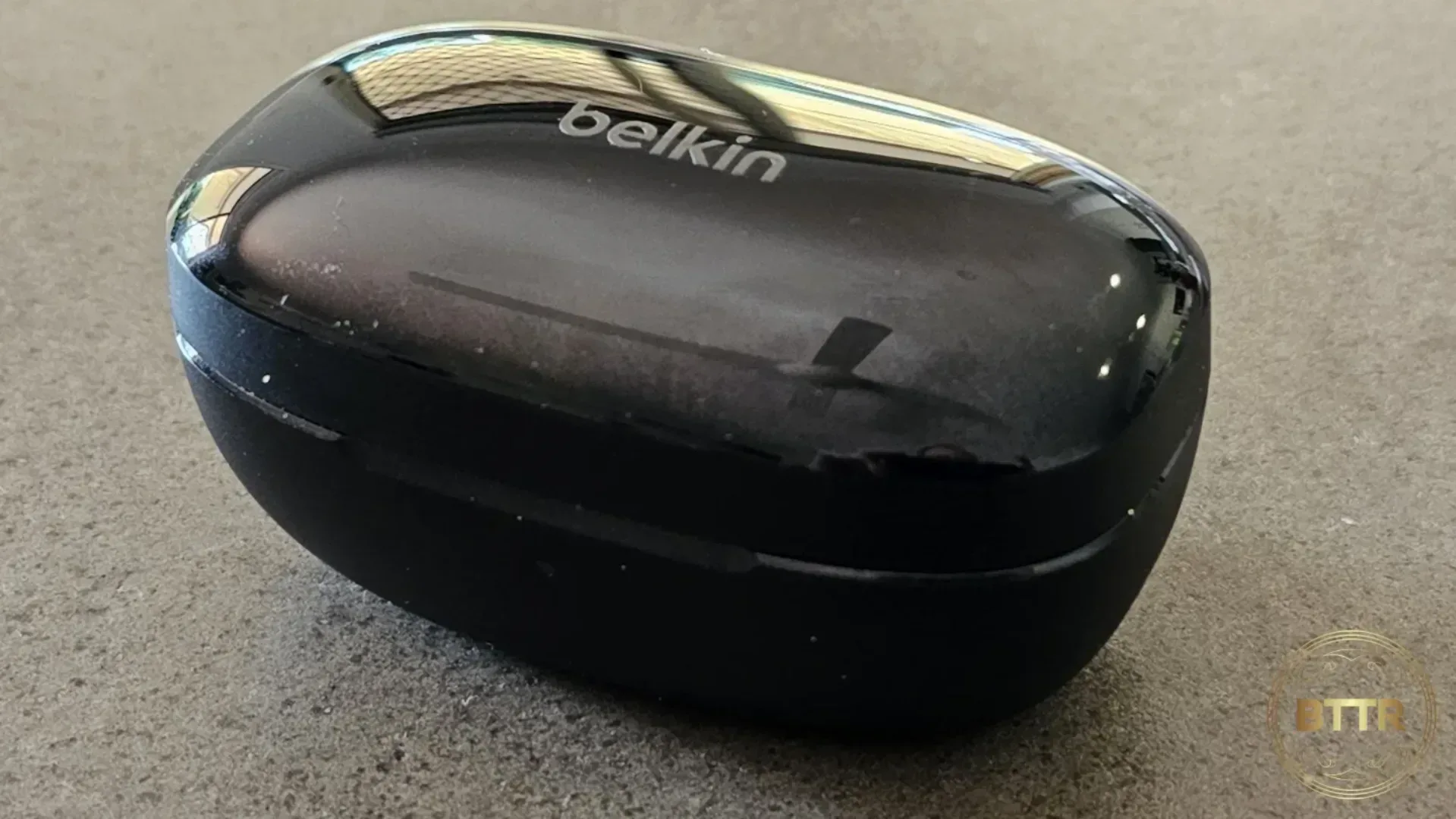 Belkin Soundform Immerse earphones on a table in the case