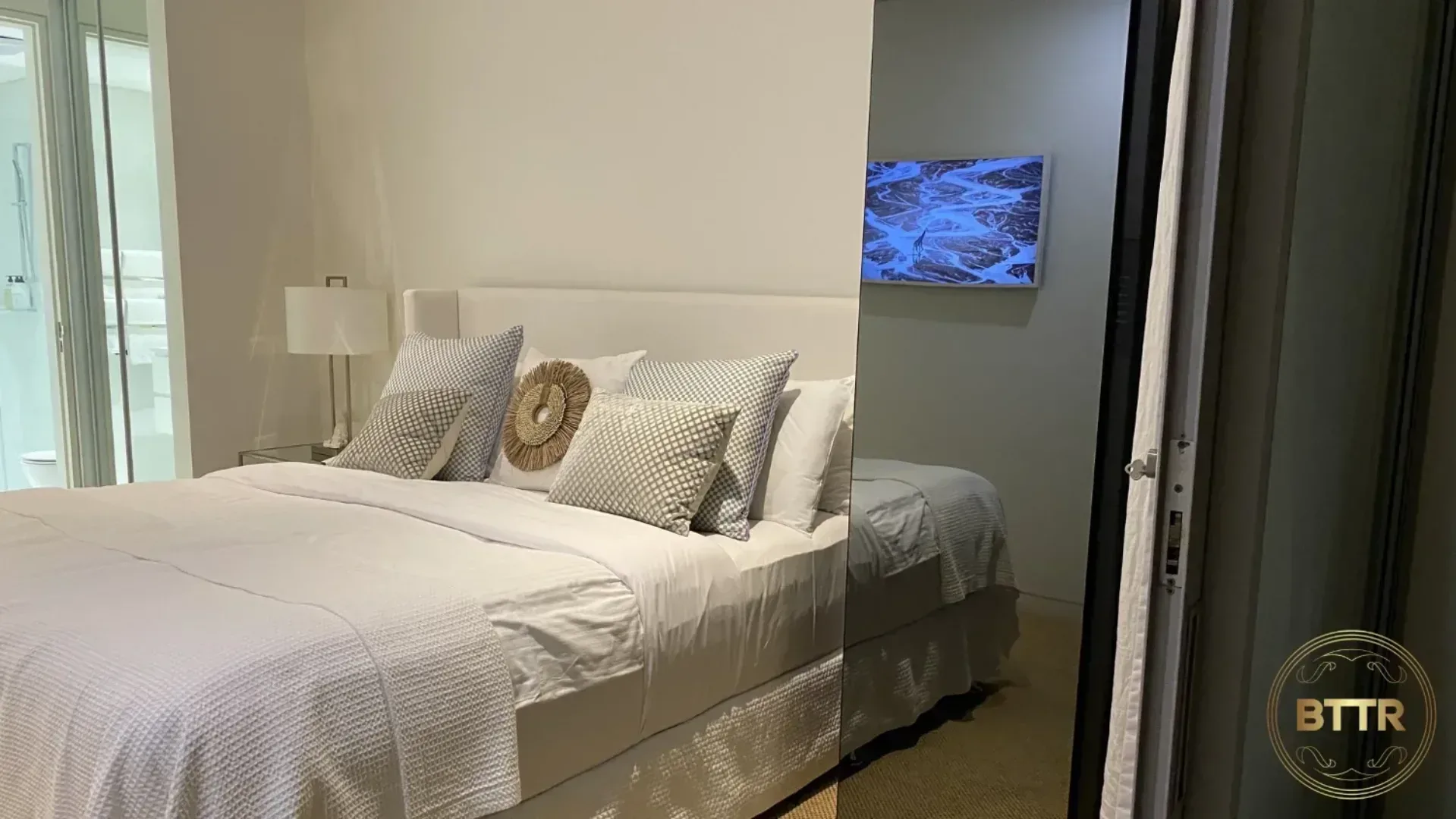 The Samsung Bespoke AirDresser set up next to a bed